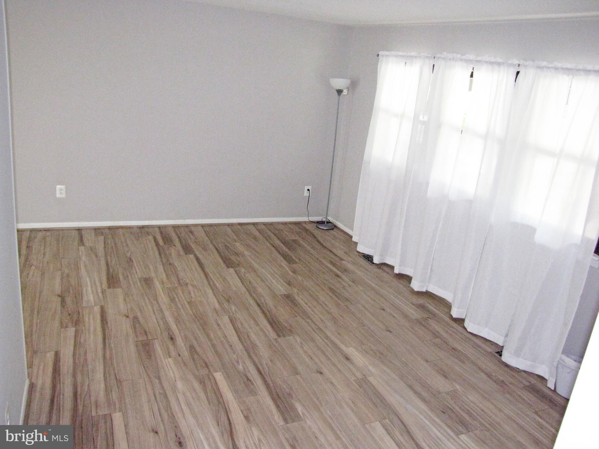 9600 Farewell Road Columbia, MD 21045 - Photo 4 of 18 a view of an empty room with wooden floor and a window