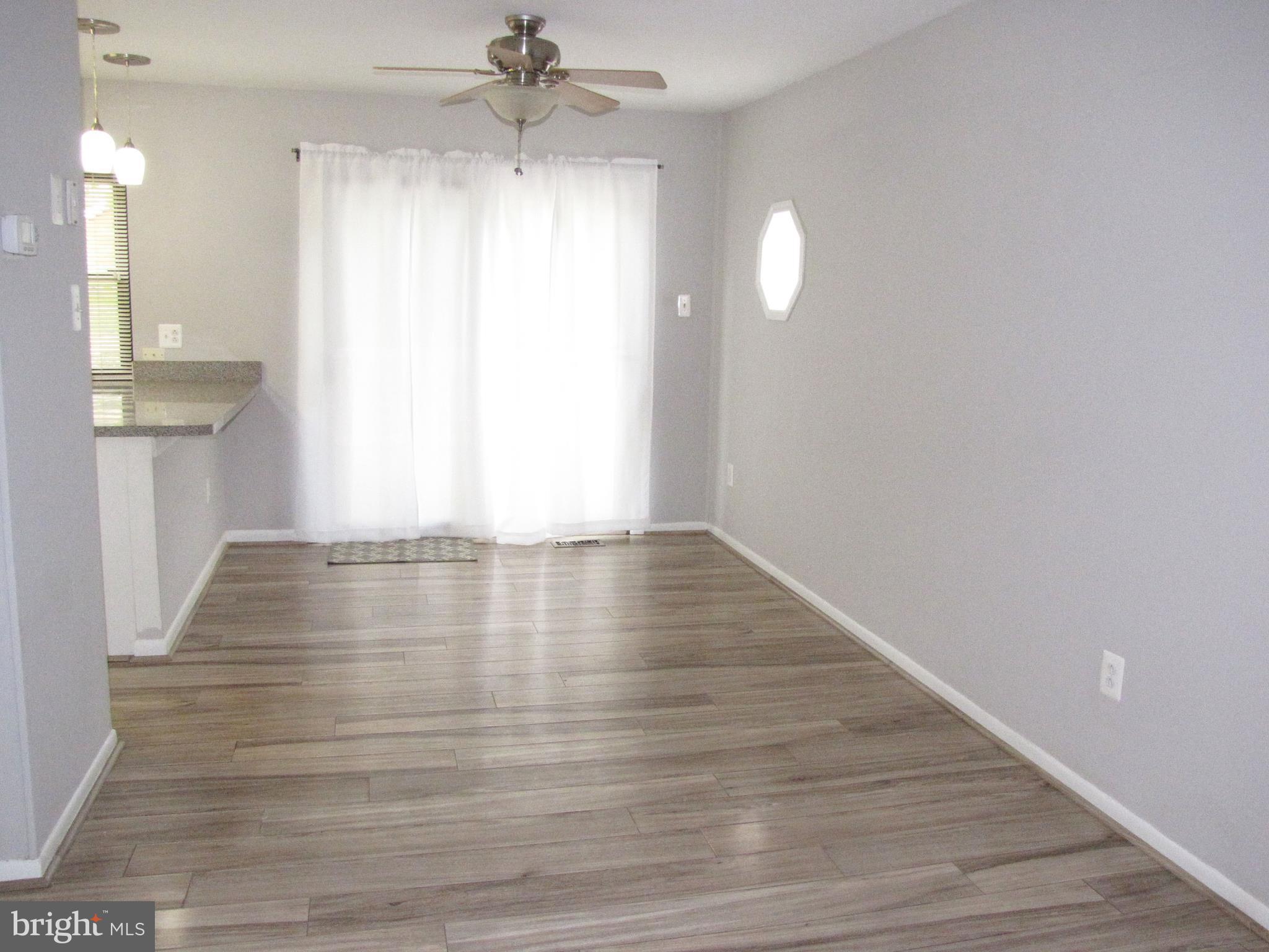 9600 Farewell Road Columbia, MD 21045 - Photo 5 of 18 a view of empty room with wooden floor and fan