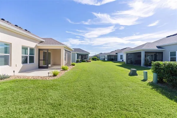 a view of a house with a yard and sitting area