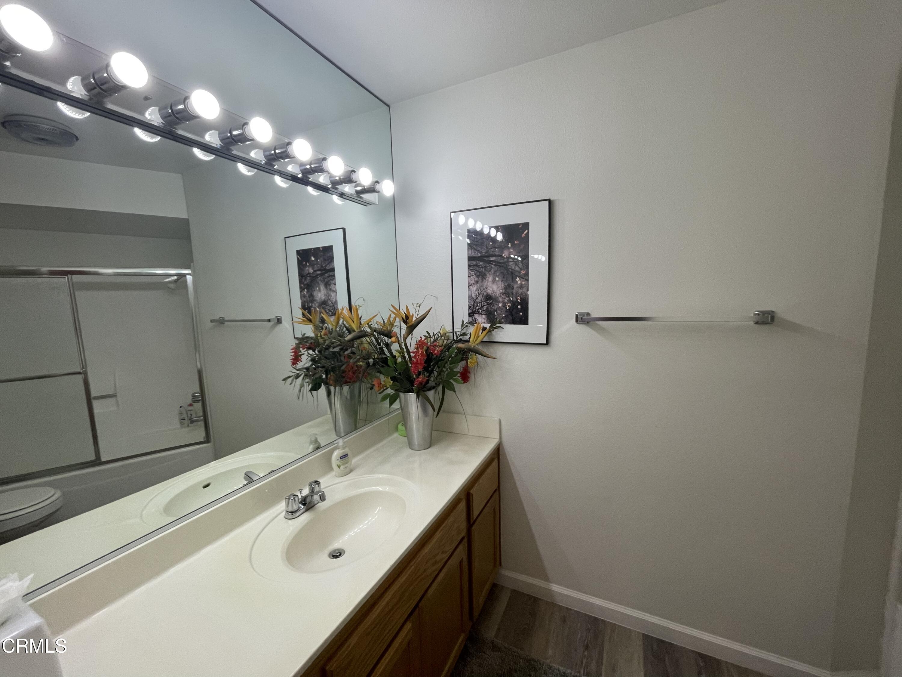 2901 Peninsula Road, Unit 144 Oxnard, CA 93035 - Photo 15 of 25 a bathroom with a sink vanity and a mirror