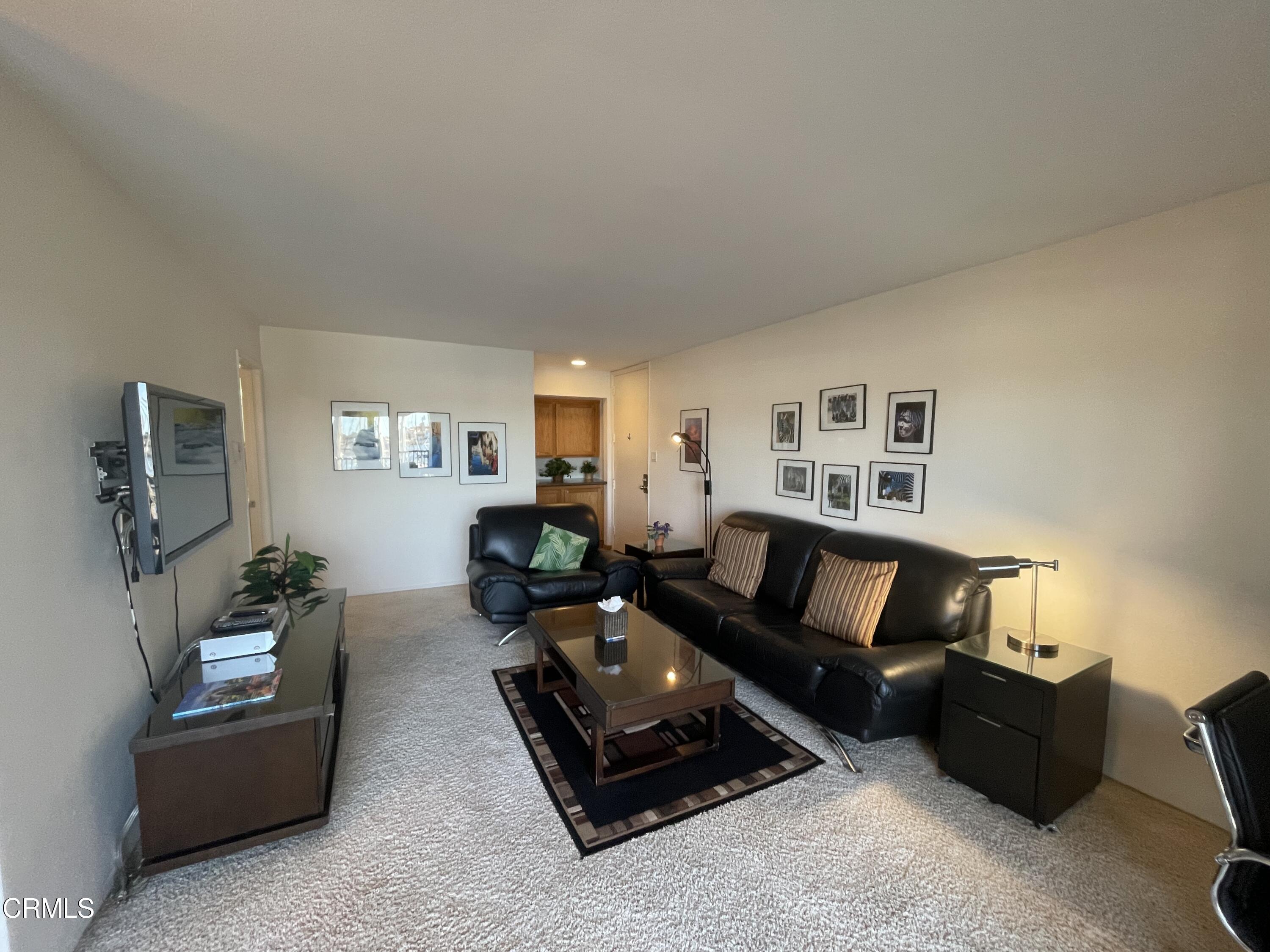 2901 Peninsula Road, Unit 144 Oxnard, CA 93035 - Photo 18 of 25 a living room with furniture and a flat screen tv