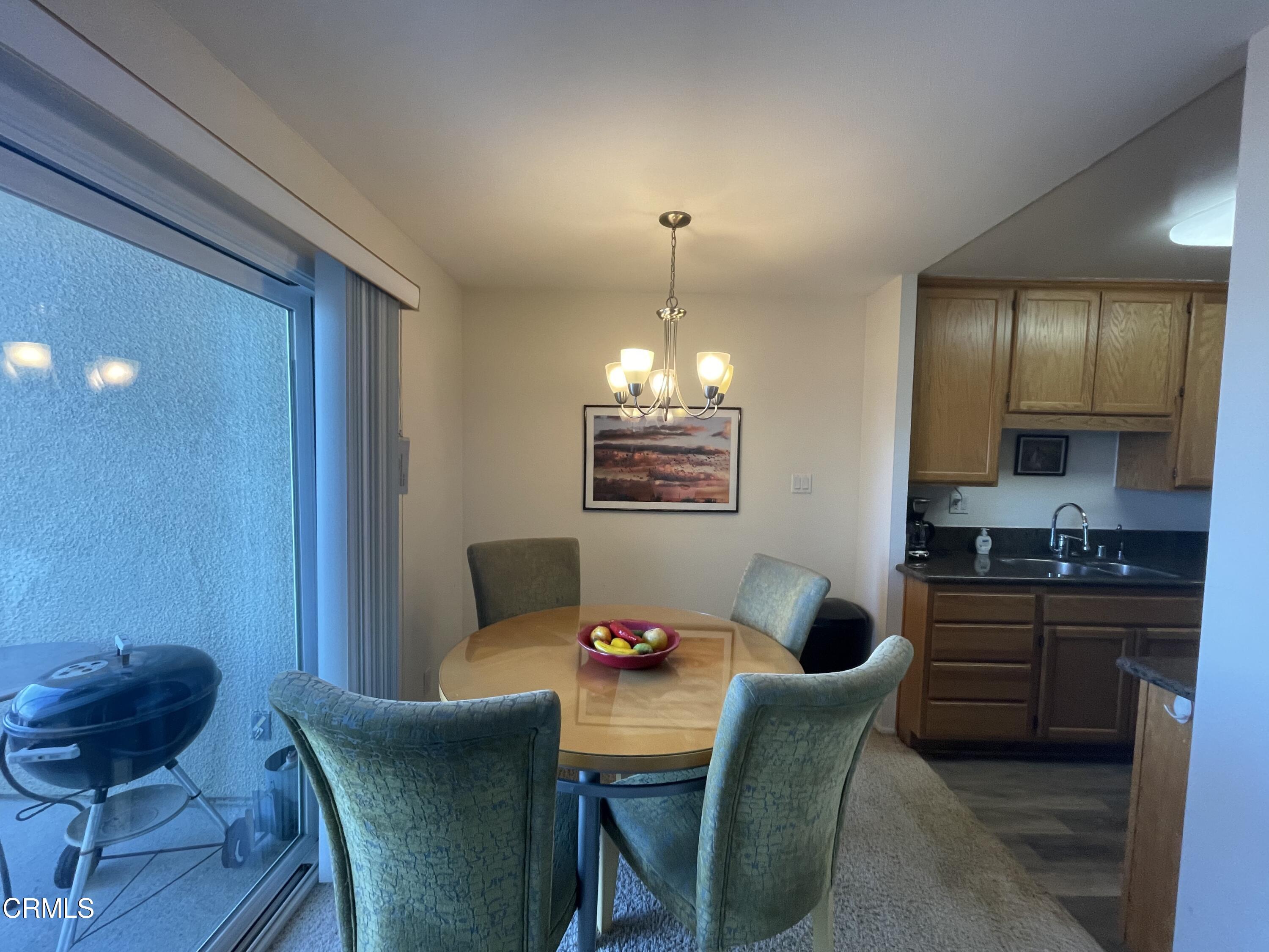2901 Peninsula Road, Unit 144 Oxnard, CA 93035 - Photo 24 of 25 a dining room with furniture and window