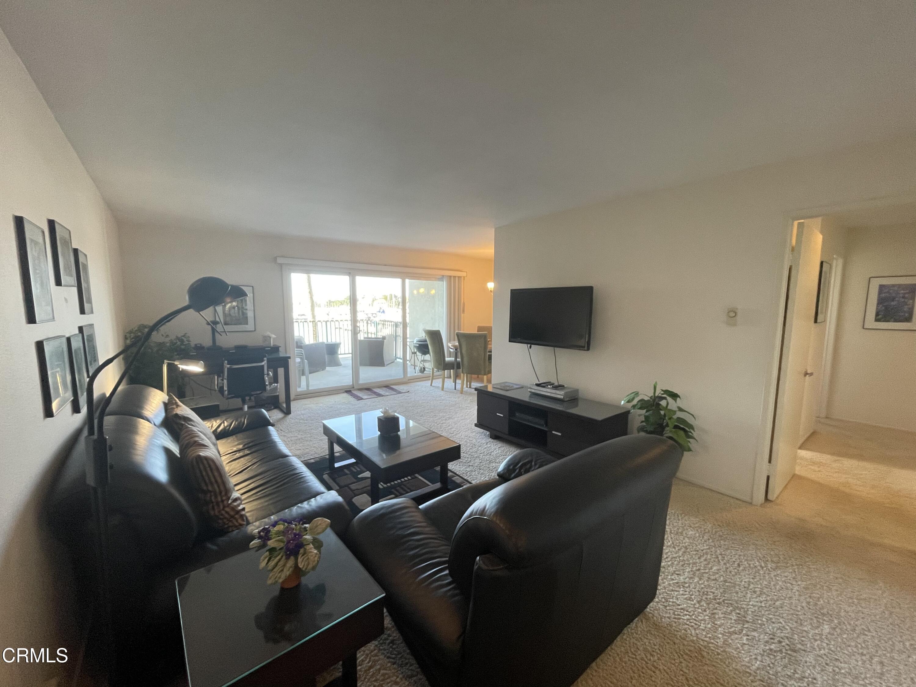 2901 Peninsula Road, Unit 144 Oxnard, CA 93035 - Photo 5 of 25 a living room with furniture and a flat screen tv