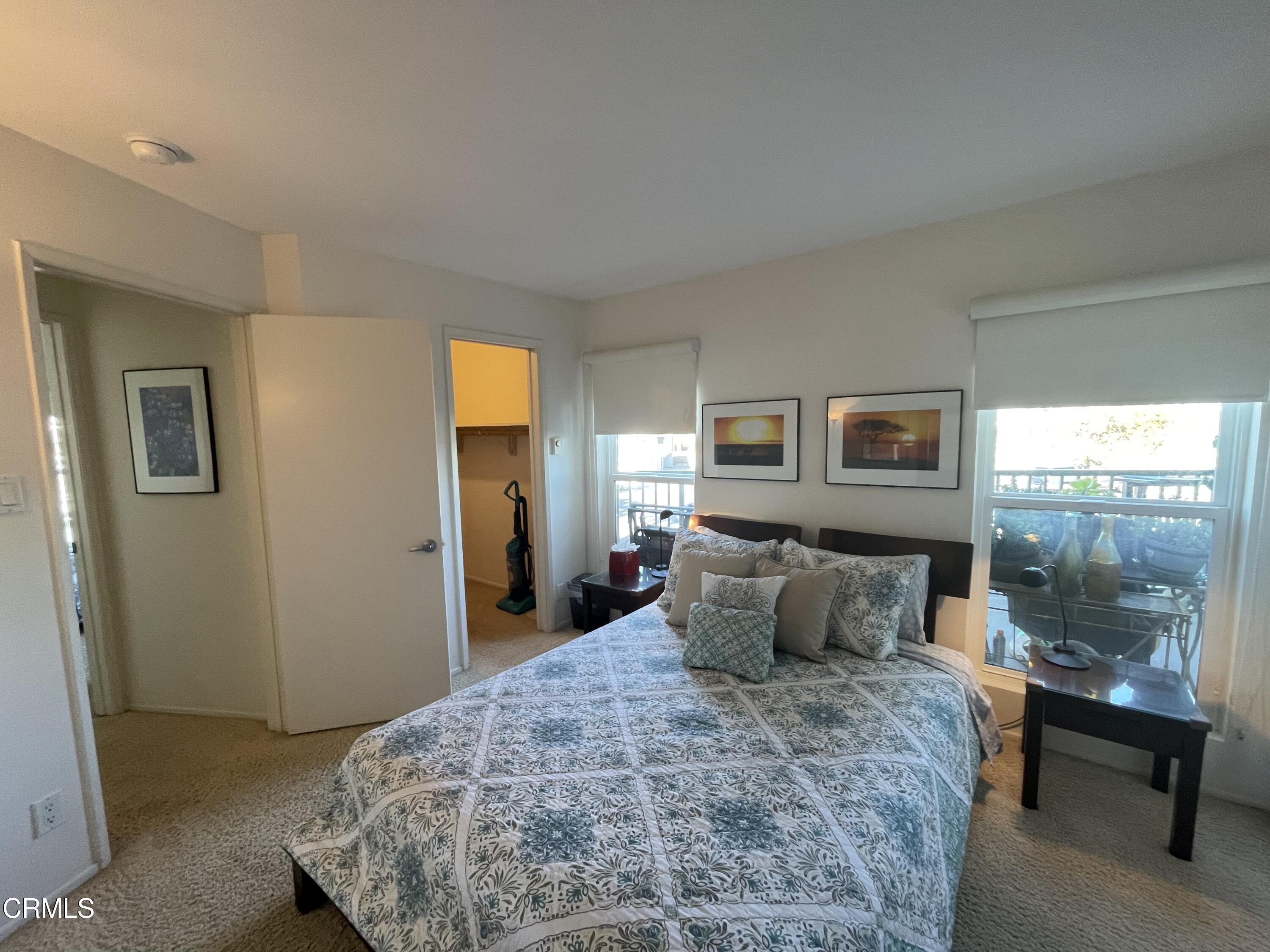 2901 Peninsula Road, Unit 144 Oxnard, CA 93035 - Photo 7 of 25 a bedroom with a bed and wooden floor