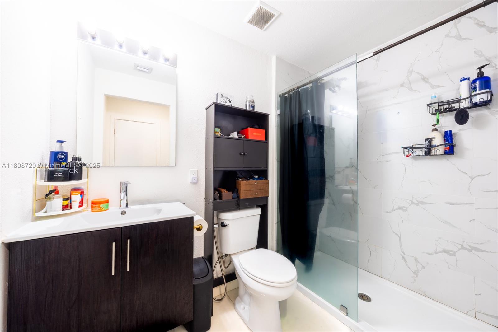 13966 Southwest 258th Street Homestead, FL 33032 - Photo 11 of 23 a bathroom with a sink toilet and shower