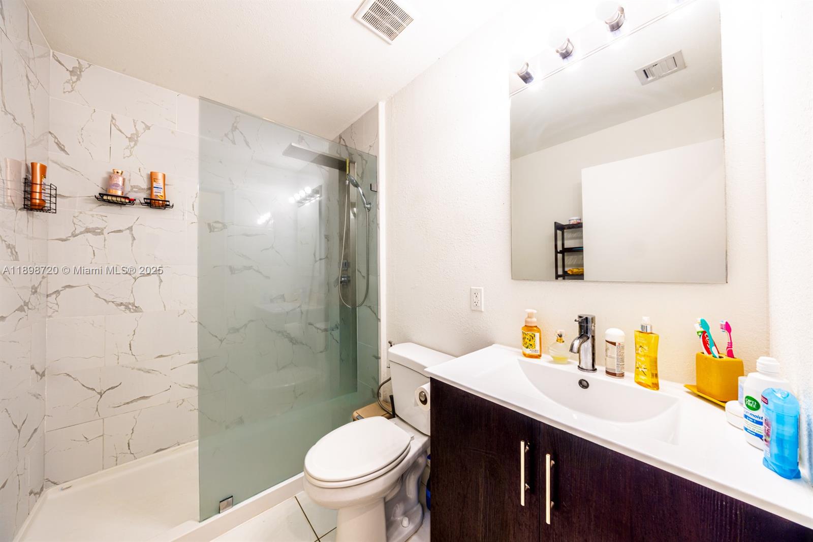 13966 Southwest 258th Street Homestead, FL 33032 - Photo 14 of 23 a bathroom with a sink toilet vanity and shower