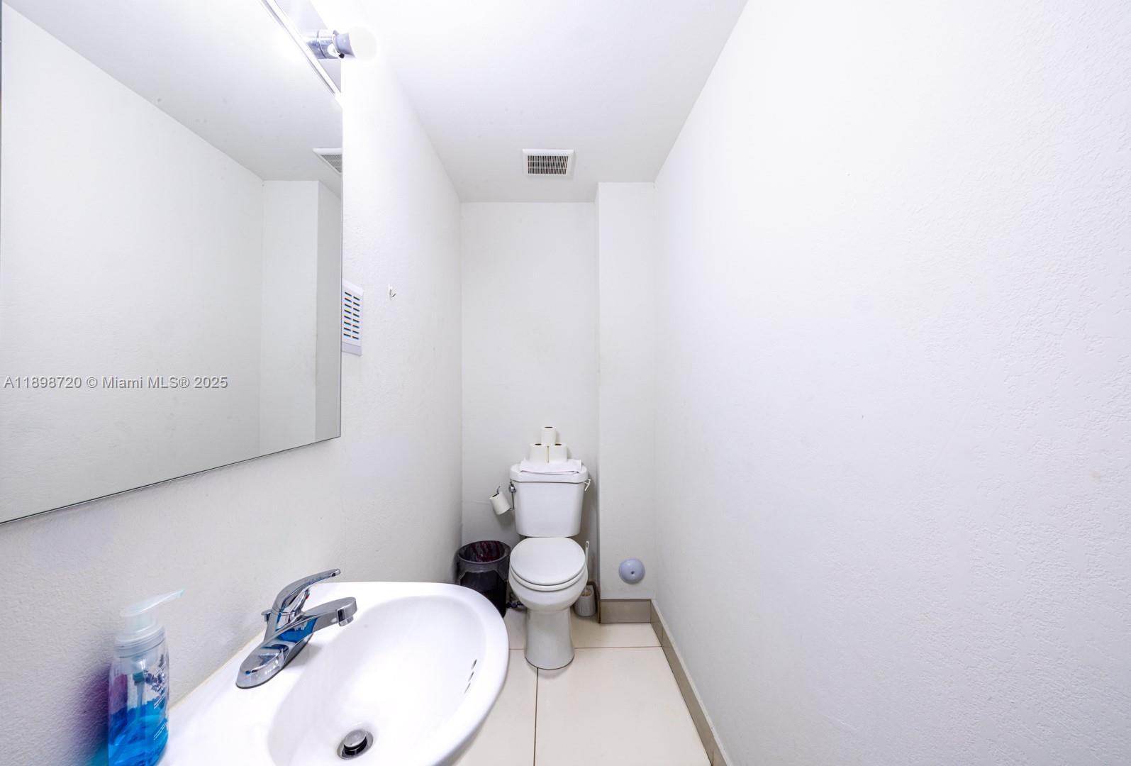 13966 Southwest 258th Street Homestead, FL 33032 - Photo 17 of 23 a bathroom with a sink and a toilet