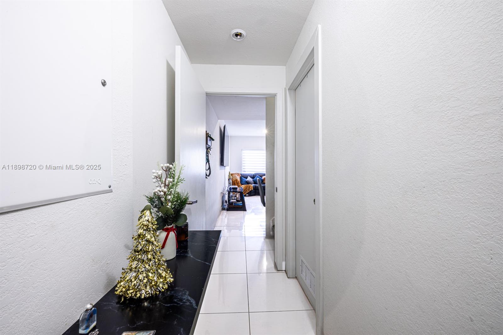 13966 Southwest 258th Street Homestead, FL 33032 - Photo 21 of 23 a hallway with potted plants and a dining table