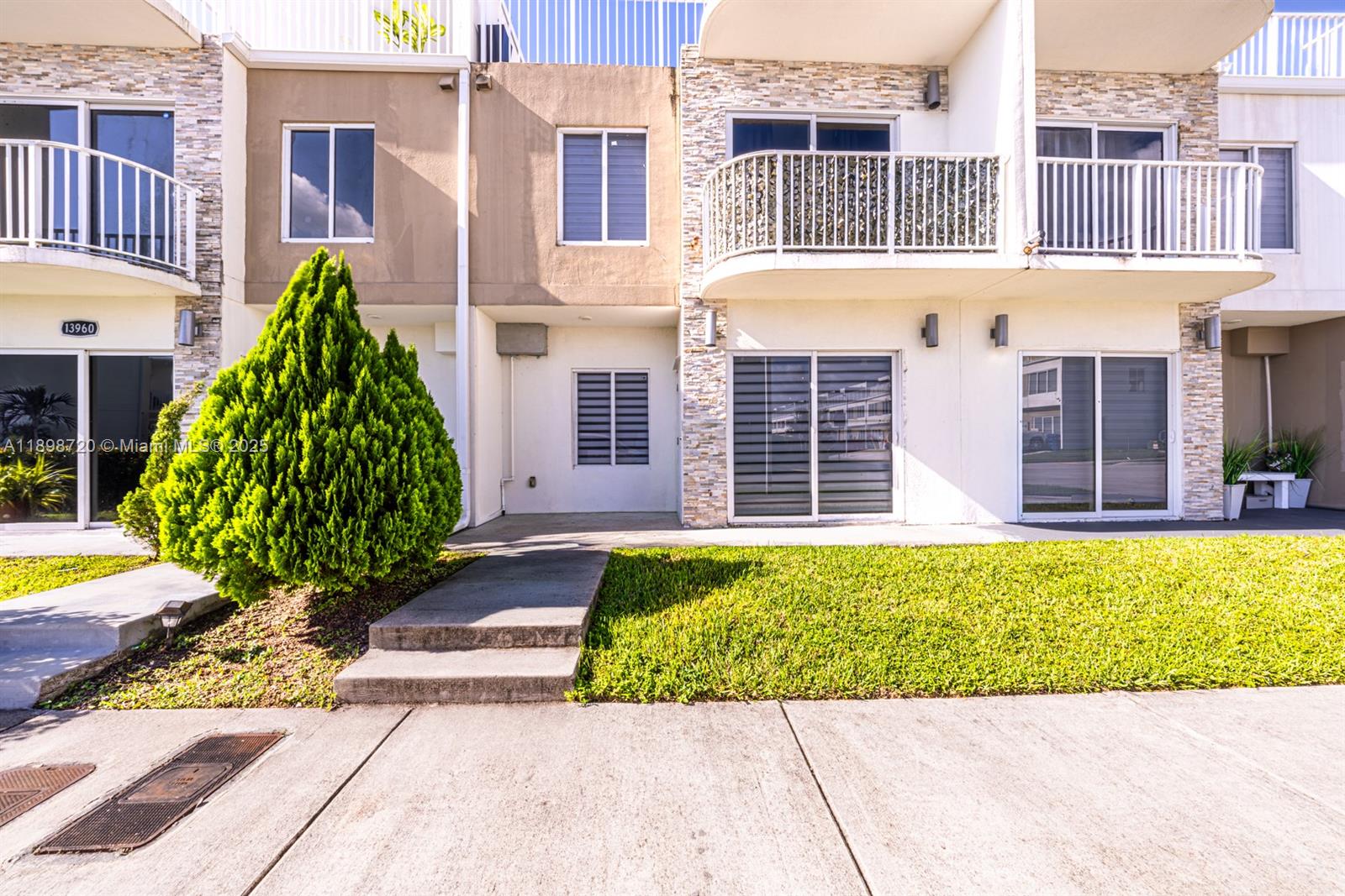 13966 Southwest 258th Street Homestead, FL 33032 - Photo 23 of 23 a view of a house with a small yard and plants