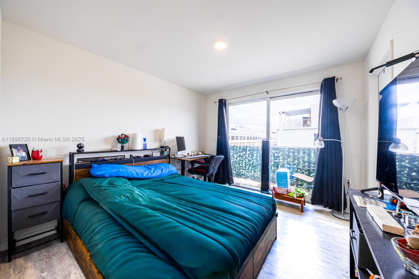 13966 Southwest 258th Street Homestead, FL 33032 - Photo 10 of 23 a bedroom with a bed and large windows