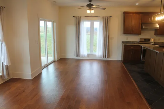 a view of an empty room with wooden floor