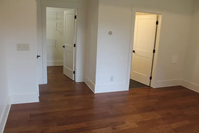 a bathroom with a granite countertop sink a toilet and a mirror
