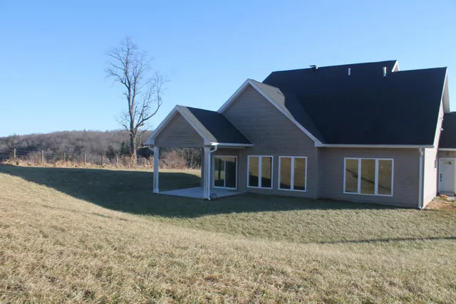 an empty room with wooden floor and entrance