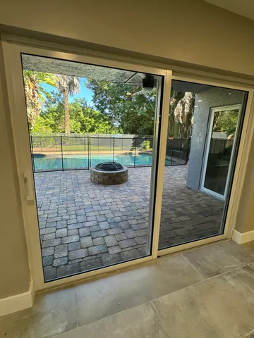 a living room with kitchen furniture a flat screen tv and a large window