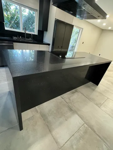 a bathroom with a shower and a sink