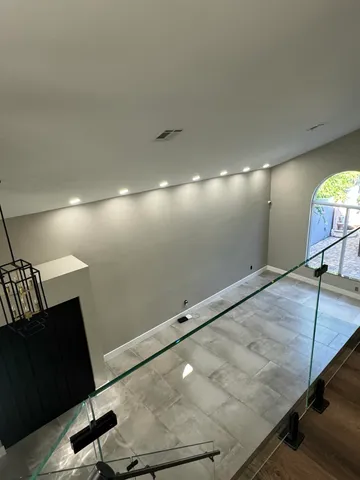 a bathroom with a granite countertop sink a toilet a mirror and shower