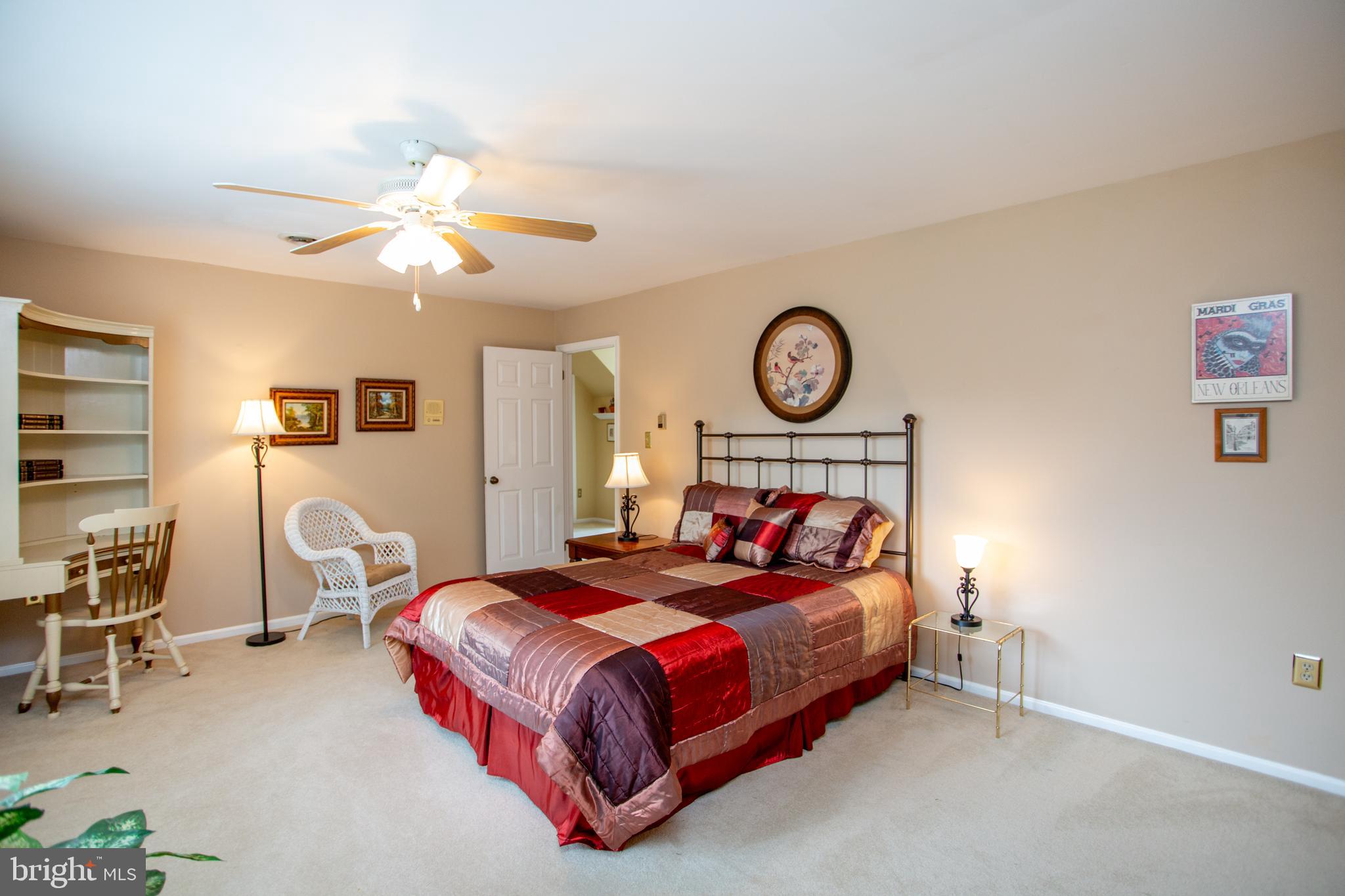 950 Camelot Road Furlong, PA 18925 - Photo 50 of 106 a bedroom with a bed chair and a chandelier