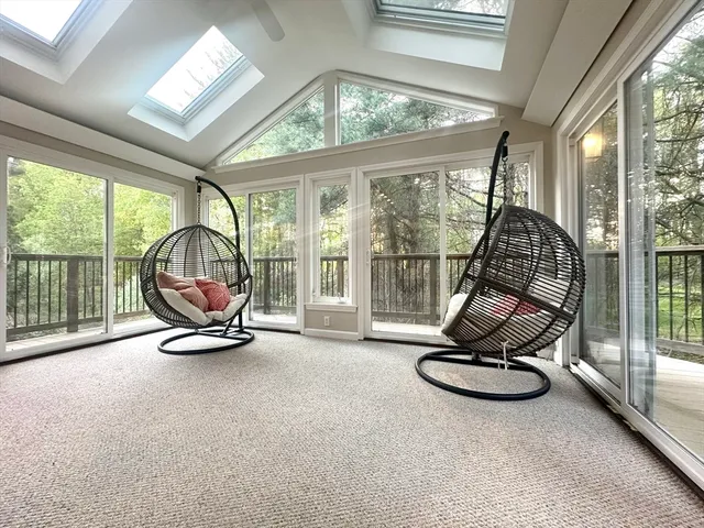 a view of a room with furniture wooden floor and windows