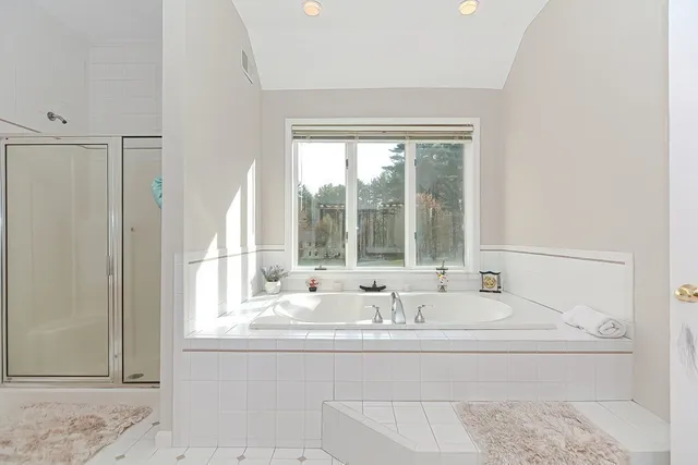 a bathroom with bathtub and window