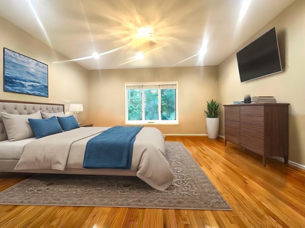 104 Channing Road Concord, MA 01742 - Photo 17 of 28 a bedroom with a large bed and a flat screen tv