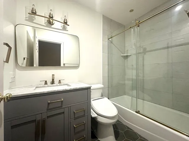 a bathroom with a toilet sink and shower