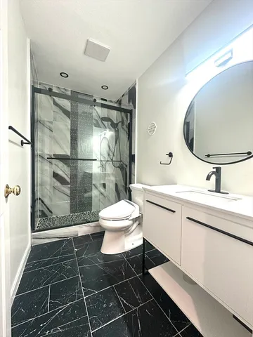 a bathroom with a sink toilet and shower