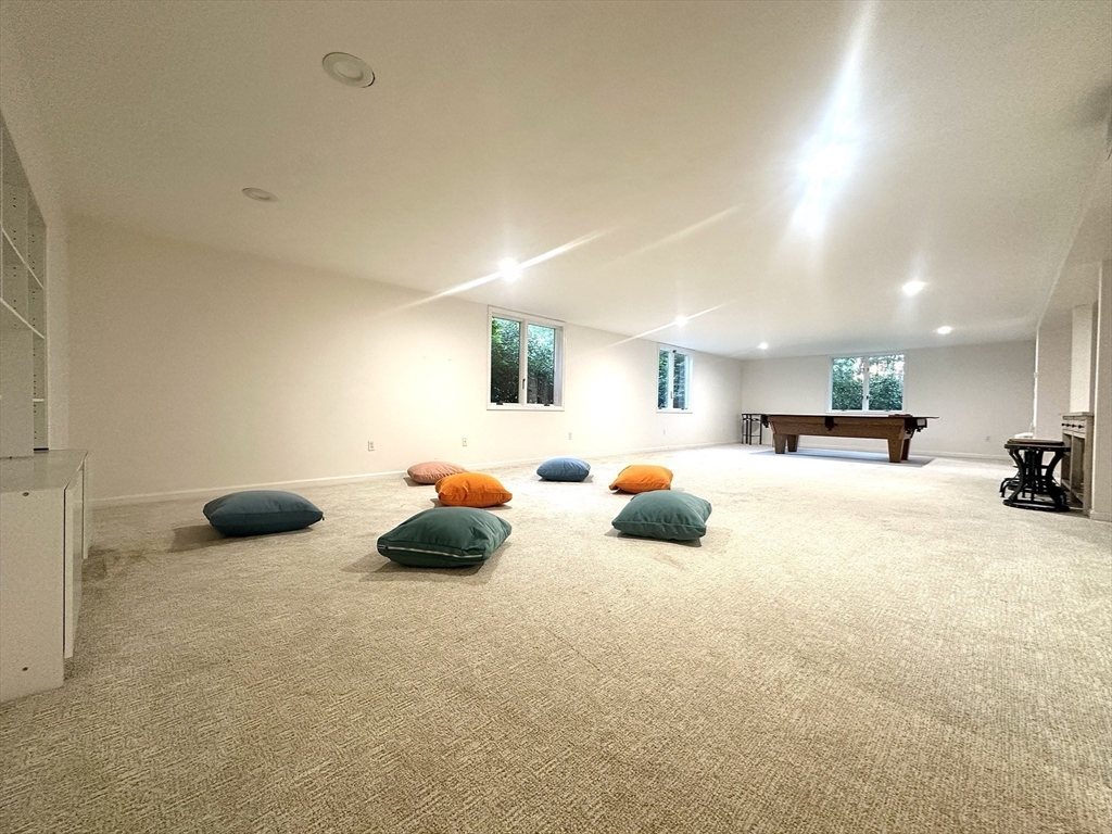 104 Channing Road Concord, MA 01742 - Photo 23 of 28 a bed room with furniture and a chandelier