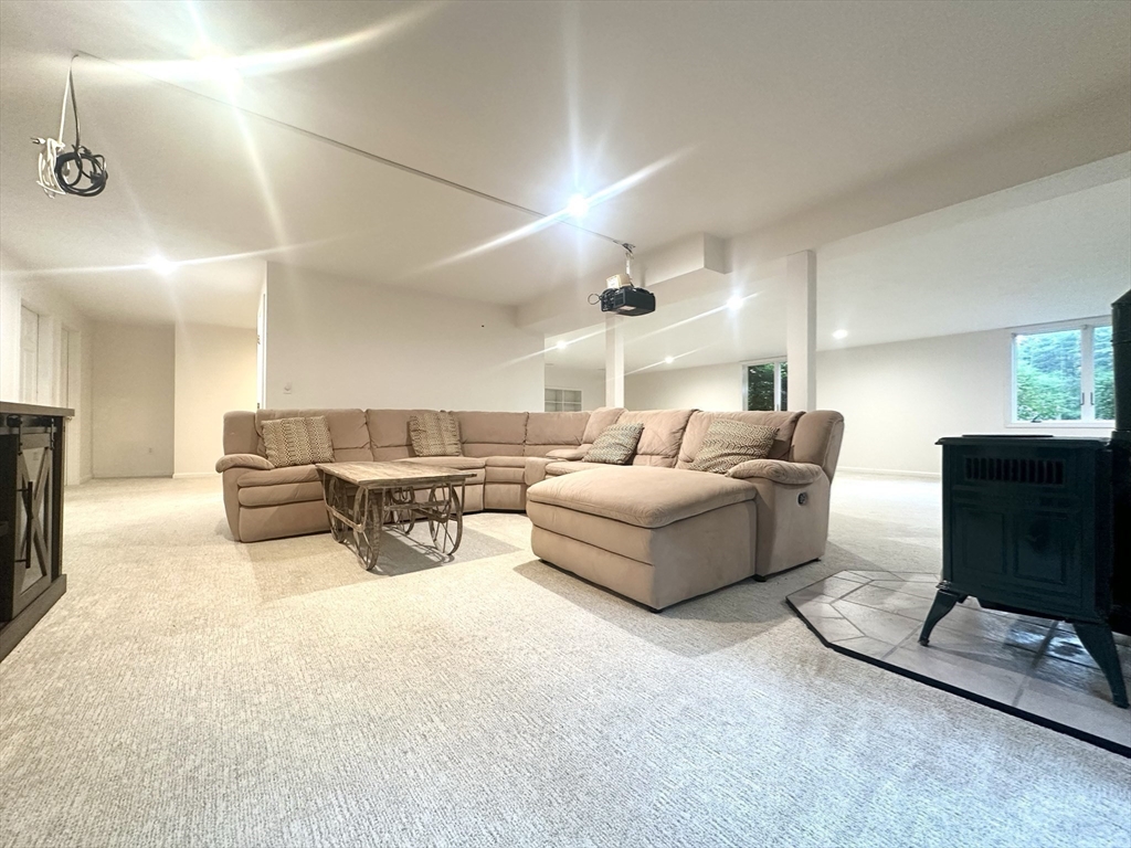 104 Channing Road Concord, MA 01742 - Photo 24 of 28 a living room with furniture a couch and a flat screen tv