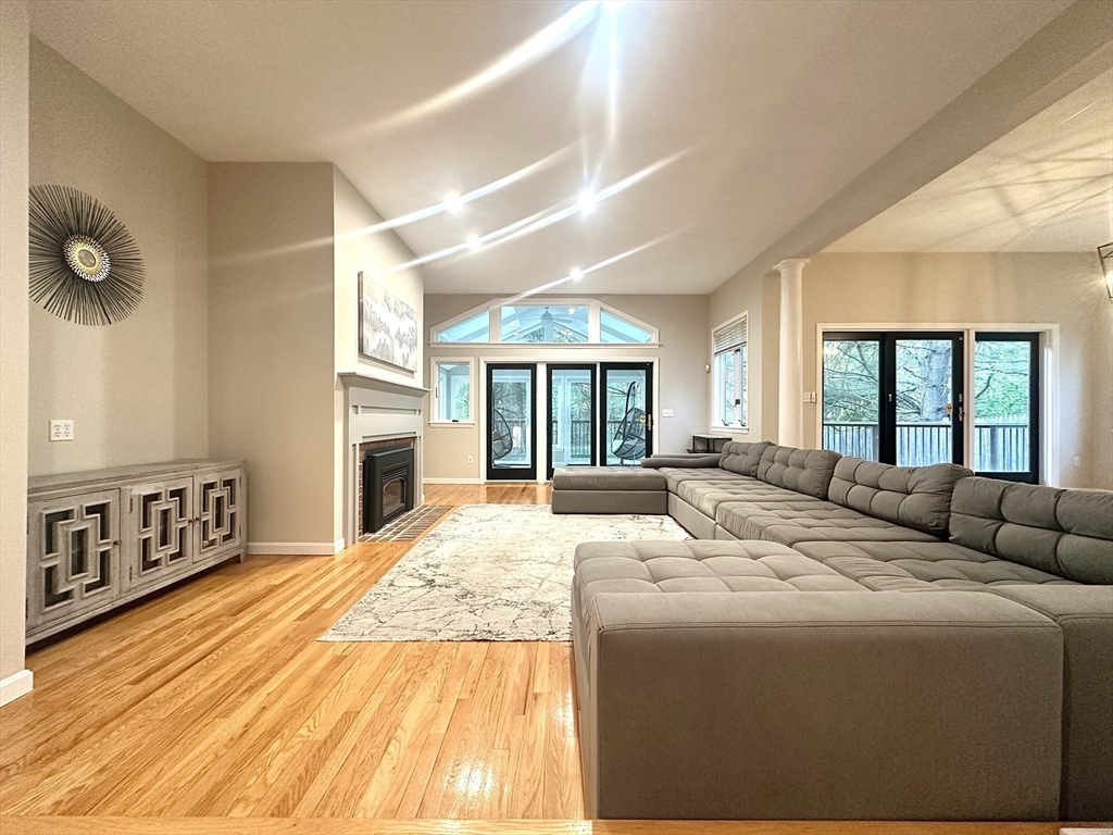104 Channing Road Concord, MA 01742 - Photo 4 of 28 a living room with large windows and a fireplace