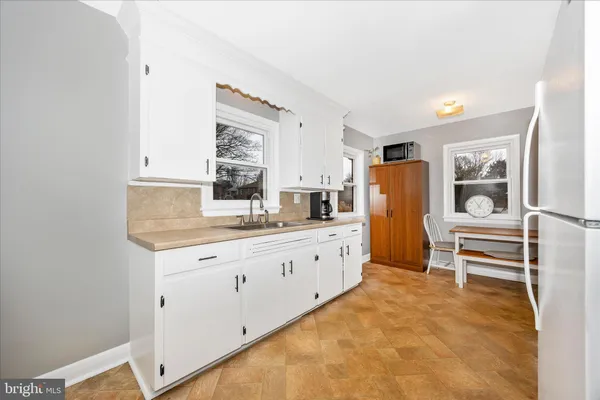 a spacious bathroom with a granite countertop sink and a mirror