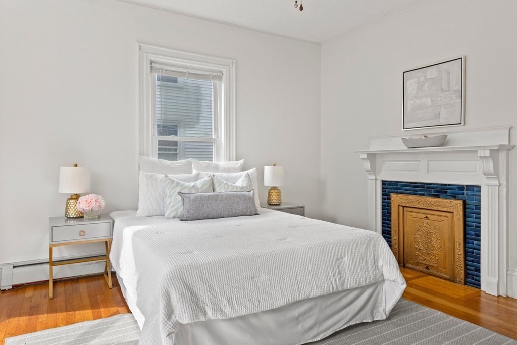 21 Boardman Street, Unit 1 Salem, MA 01970 - Photo 11 of 19 a bedroom with a bed and a fireplace