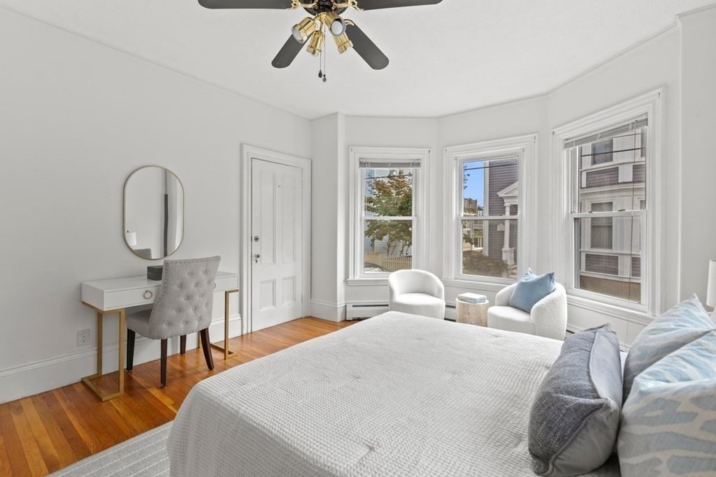 21 Boardman Street, Unit 1 Salem, MA 01970 - Photo 12 of 19 a living room with furniture a chandelier a large window and potted plants