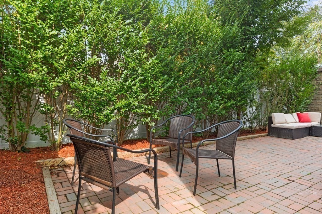 21 Boardman Street, Unit 1 Salem, MA 01970 - Photo 17 of 19 a backyard of a house with table and chairs