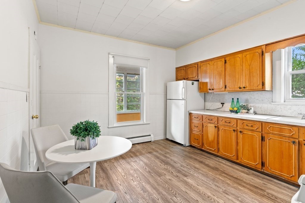 21 Boardman Street, Unit 1 Salem, MA 01970 - Photo 9 of 19 a kitchen with stainless steel appliances a sink a window and wooden floor