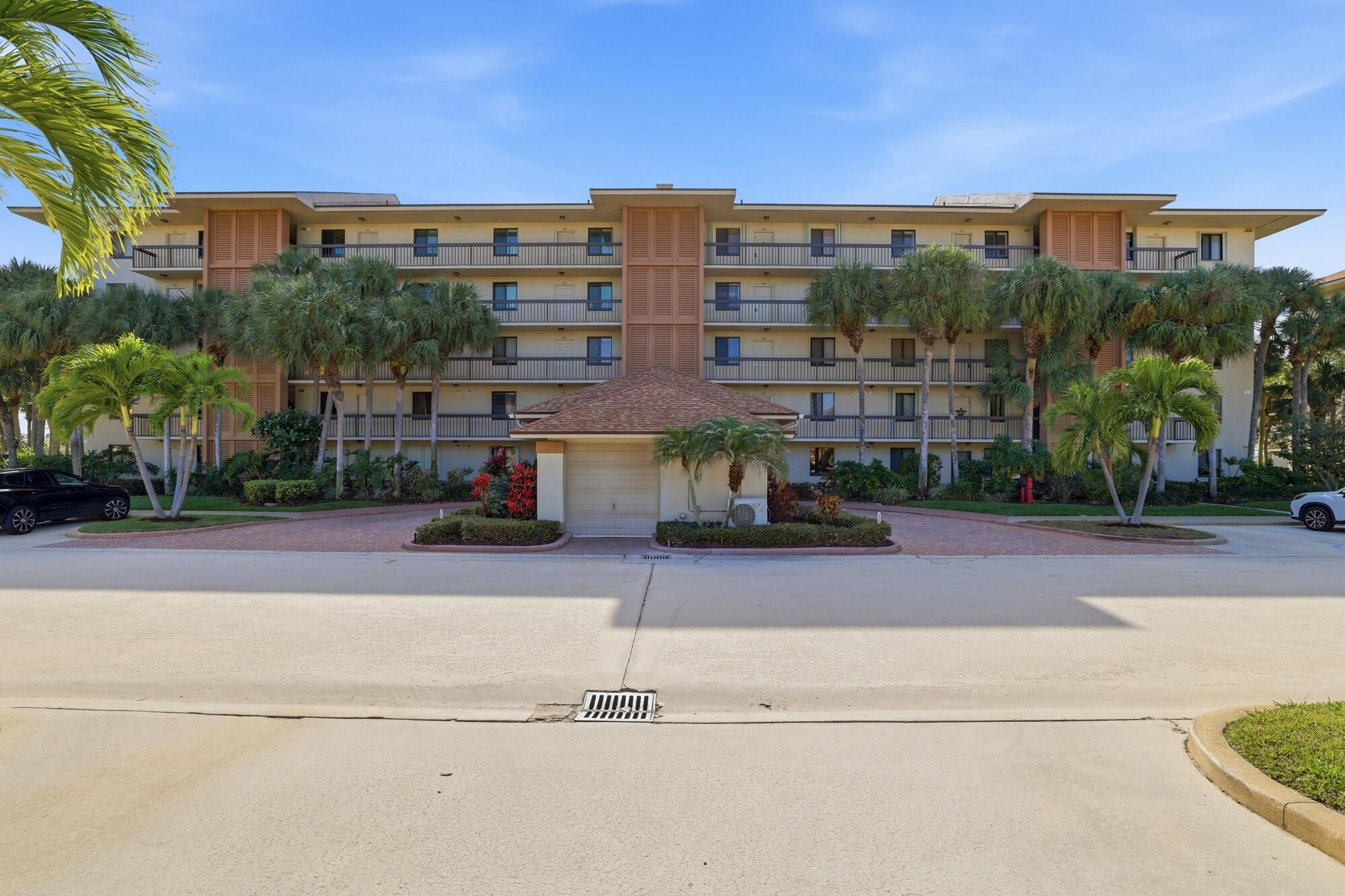 2101 Marina Isle Way, Unit 404 Jupiter, FL 33477 - Photo 17 of 17 front view of a building with a street