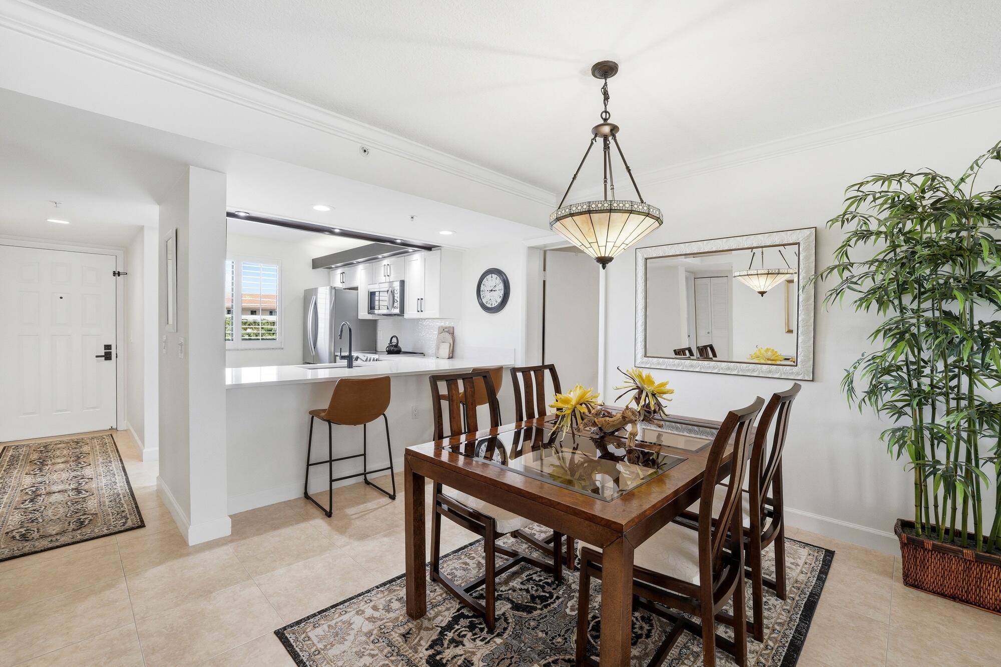 2101 Marina Isle Way, Unit 404 Jupiter, FL 33477 - Photo 3 of 17 a dining room with furniture and window