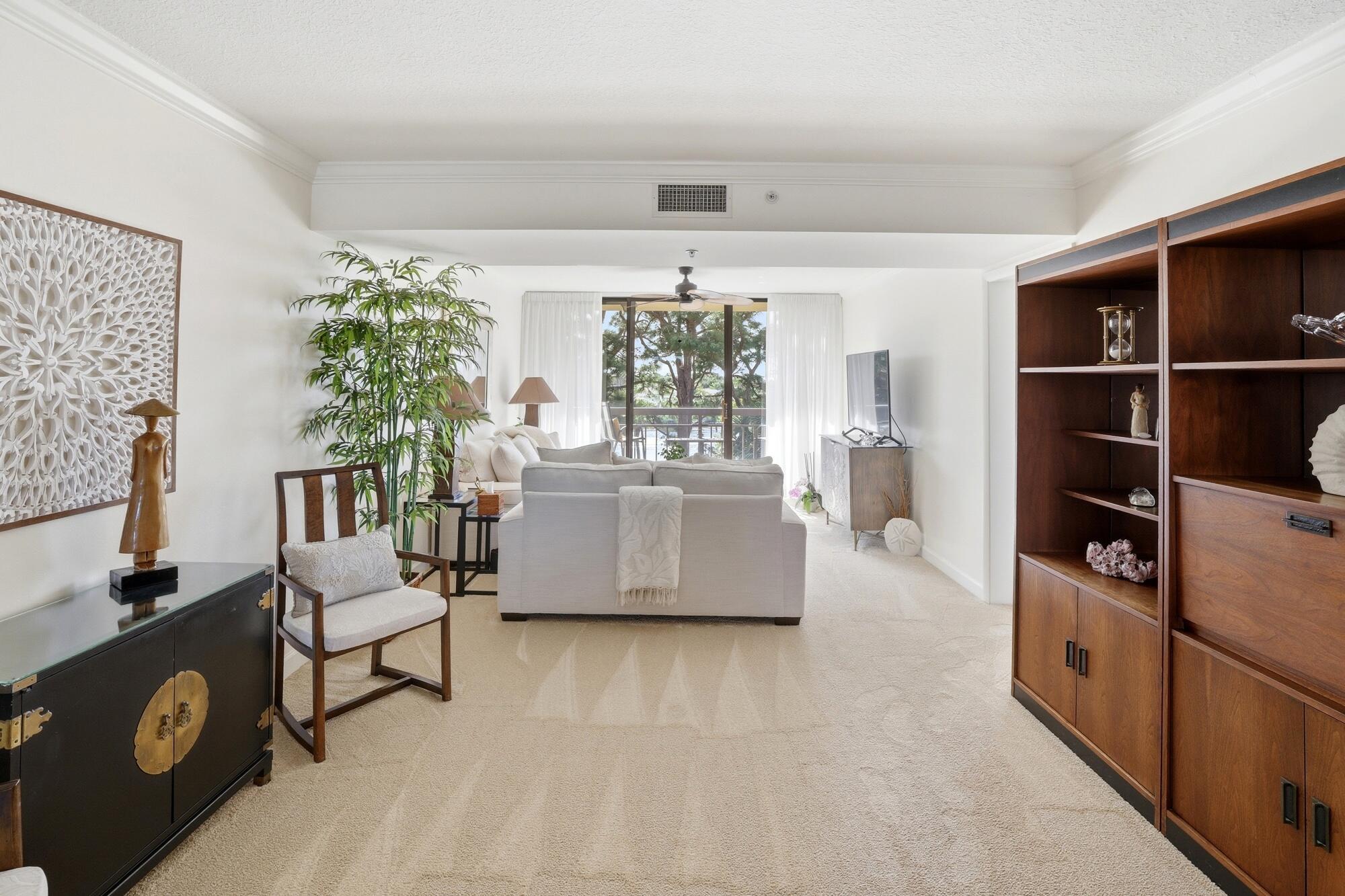 2101 Marina Isle Way, Unit 404 Jupiter, FL 33477 - Photo 4 of 17 a living room with furniture and a flat screen tv