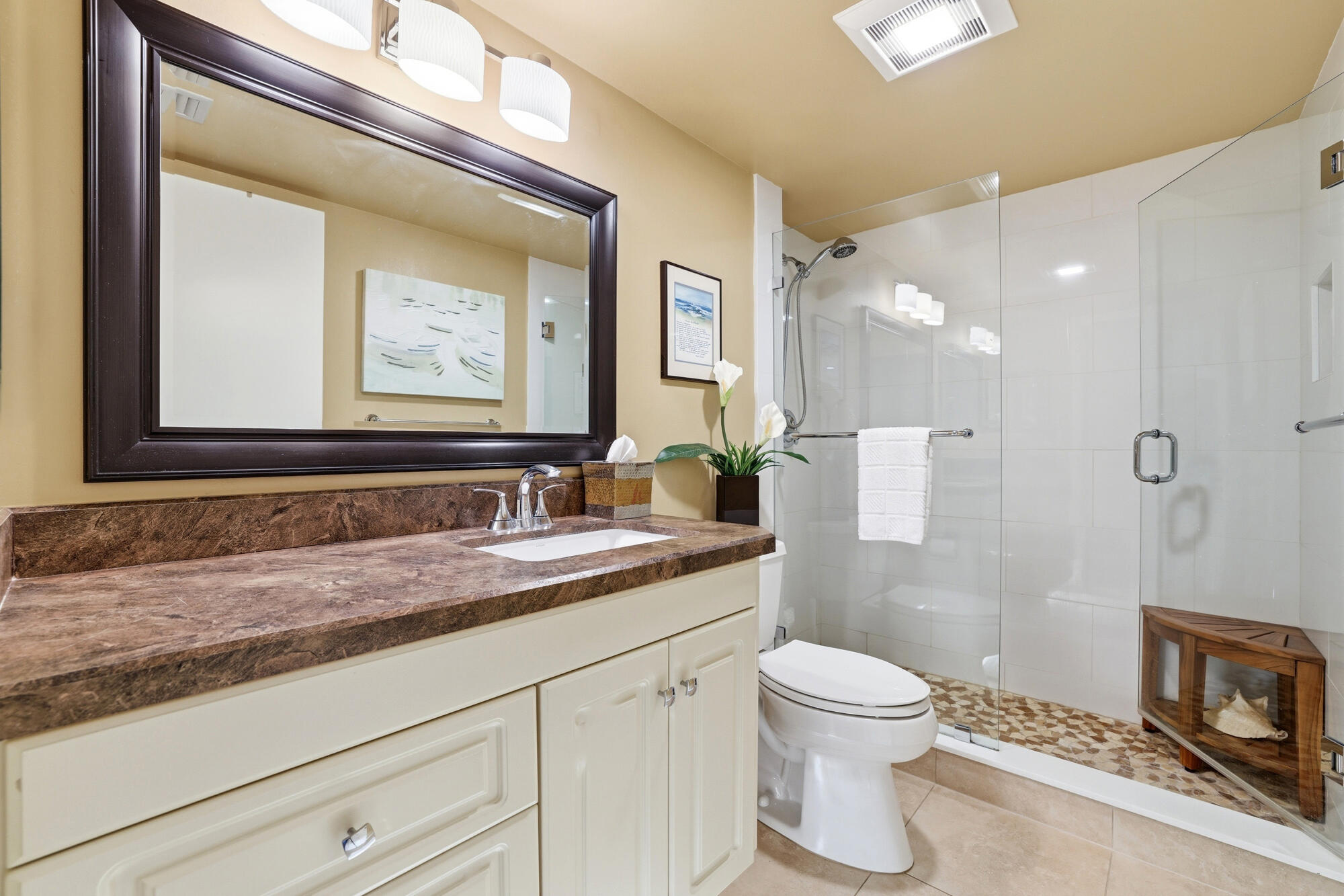 2101 Marina Isle Way, Unit 404 Jupiter, FL 33477 - Photo 10 of 17 a bathroom with a granite countertop sink a toilet and a mirror