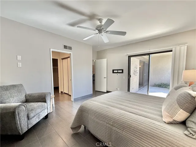 a bedroom with a bed couch and dresser