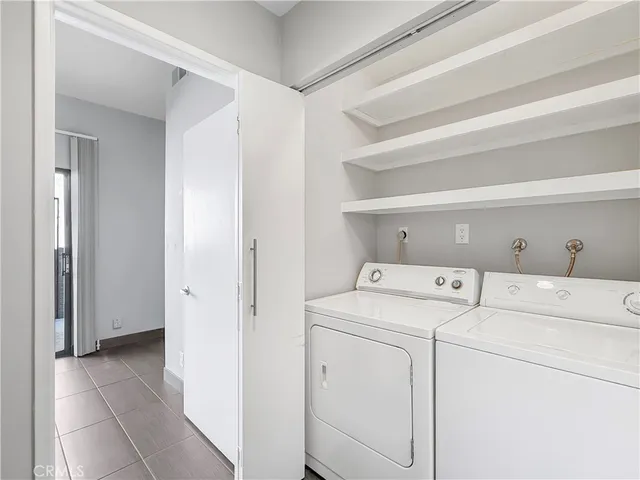 a view of storage and utility room with washer and dryer