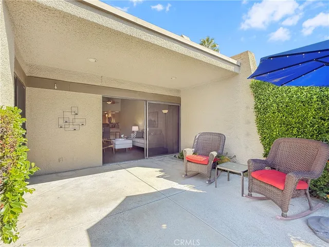 a balcony with furniture and a potted plant