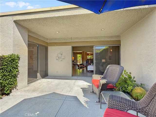 a balcony with furniture and a potted plant