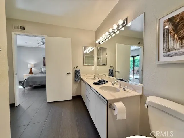 a kitchen with a stove a sink and a mirror