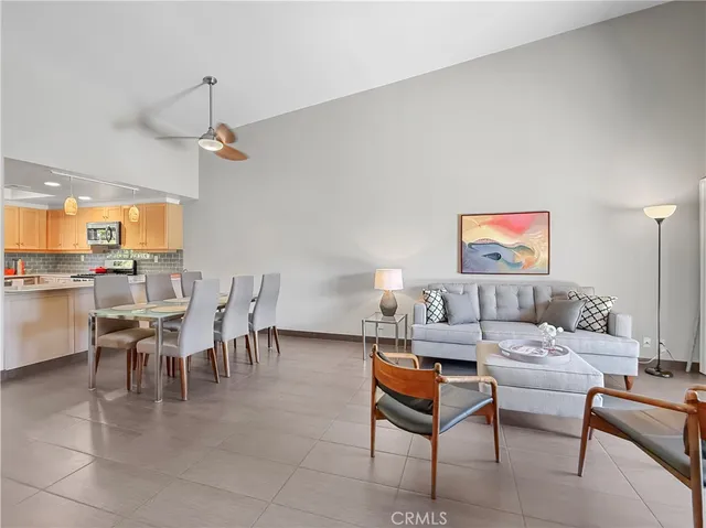 a living room with furniture a chandelier and a dining table