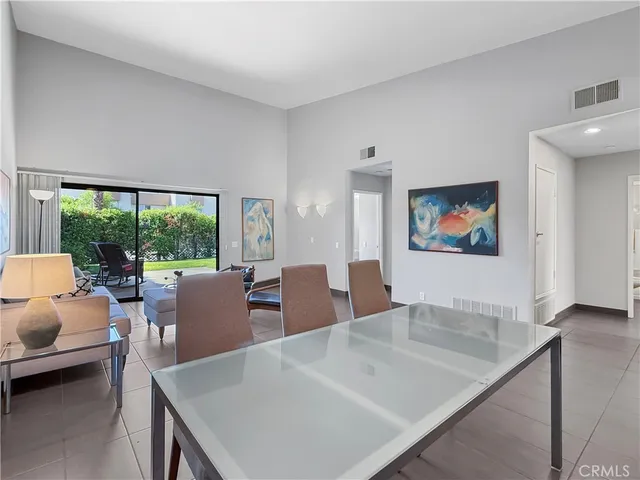 a living room with furniture a large window and a flat screen tv