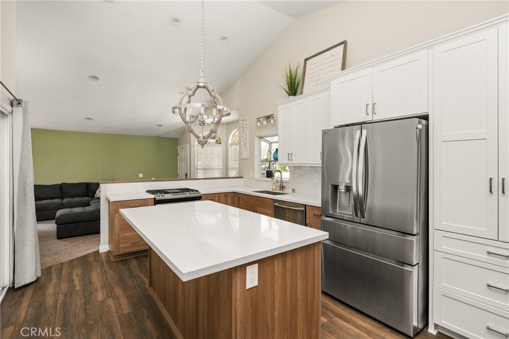 7958 East Bauer Road Anaheim, CA 92808 - Photo 14 of 45 a kitchen with a refrigerator a sink dishwasher a refrigerator and a stove with wooden floor