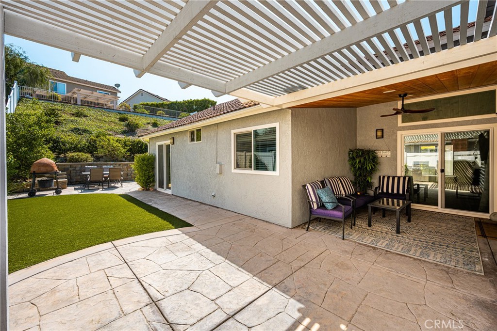 7958 East Bauer Road Anaheim, CA 92808 - Photo 16 of 45 a backyard of a house with barbeque oven table and chairs