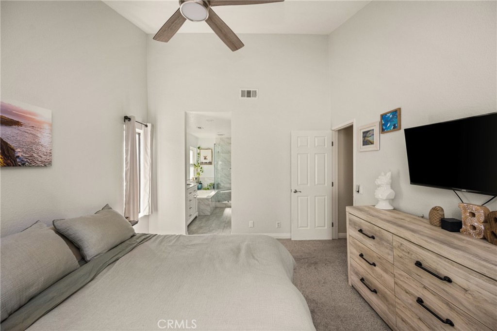 7958 East Bauer Road Anaheim, CA 92808 - Photo 23 of 45 a bedroom with a bed and a flat screen tv