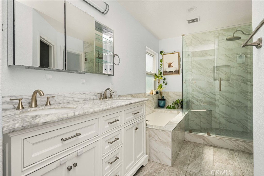 7958 East Bauer Road Anaheim, CA 92808 - Photo 24 of 45 a bathroom with a granite countertop sink a mirror and a shower