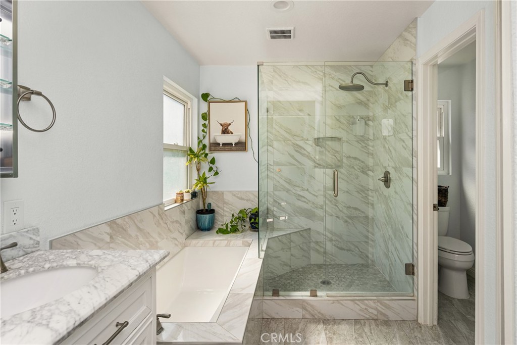 7958 East Bauer Road Anaheim, CA 92808 - Photo 25 of 45 a bathroom with a granite countertop sink mirror and shower